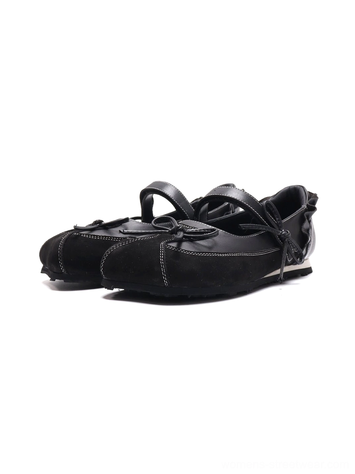 Black bow Mary Jane ballet flats pair shown from side three-quarter angle with textured upper and white contrast edge stitching