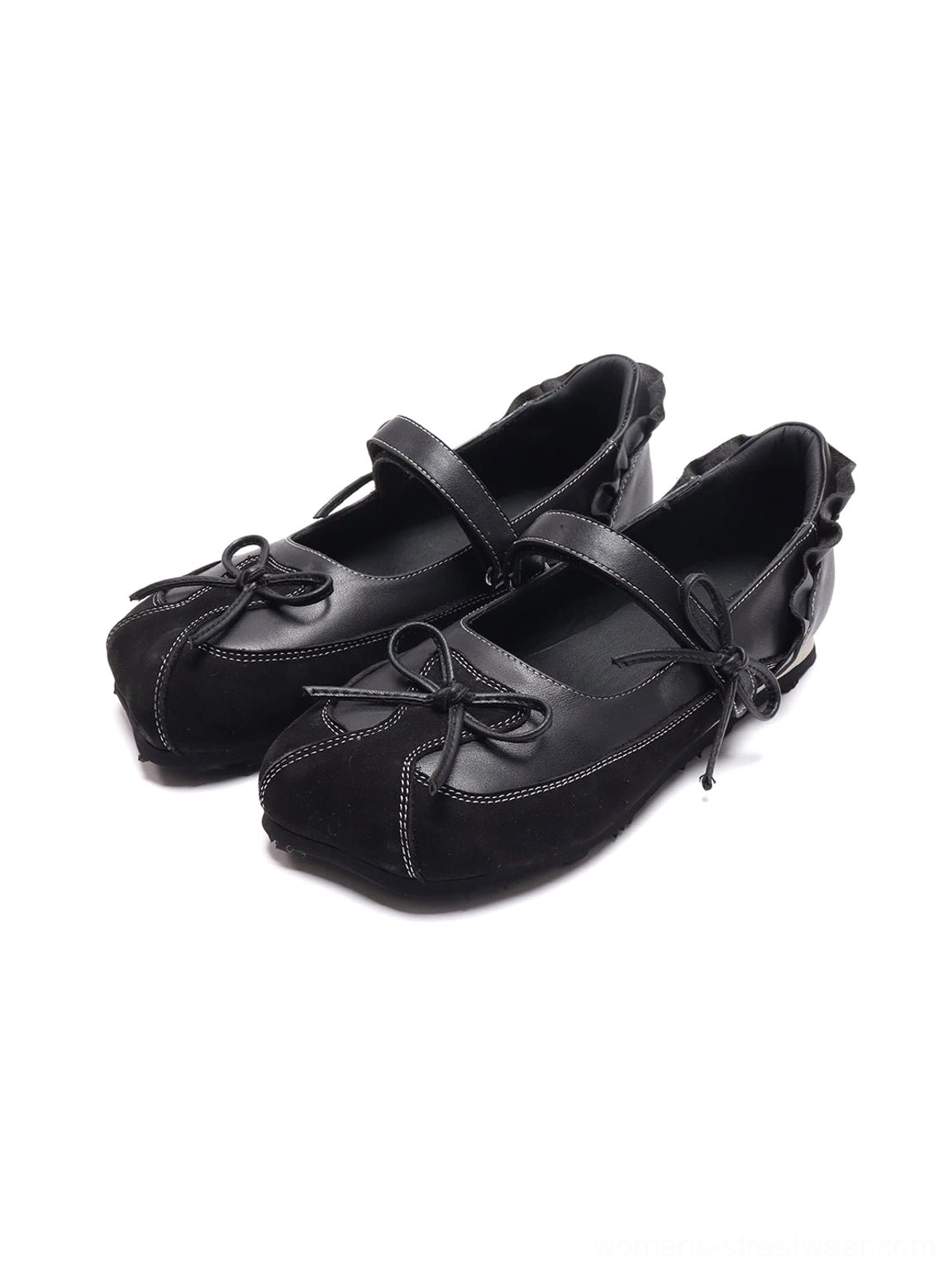 Three-quarter product view of black leather-look bow ballet flats with Mary Jane strap, ruffled trim and contrast stitching