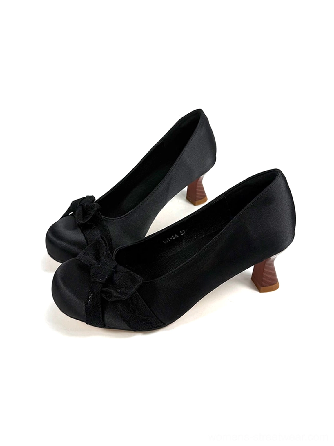 Black bow pumps shown from the right angle with smooth satin texture and tapered wood-look mid heels