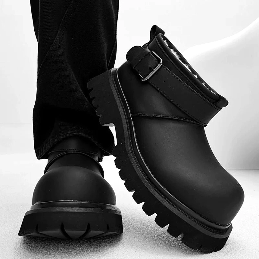 Rear-side product view of streamlined black buckle platform boots with a thick lugged sole
