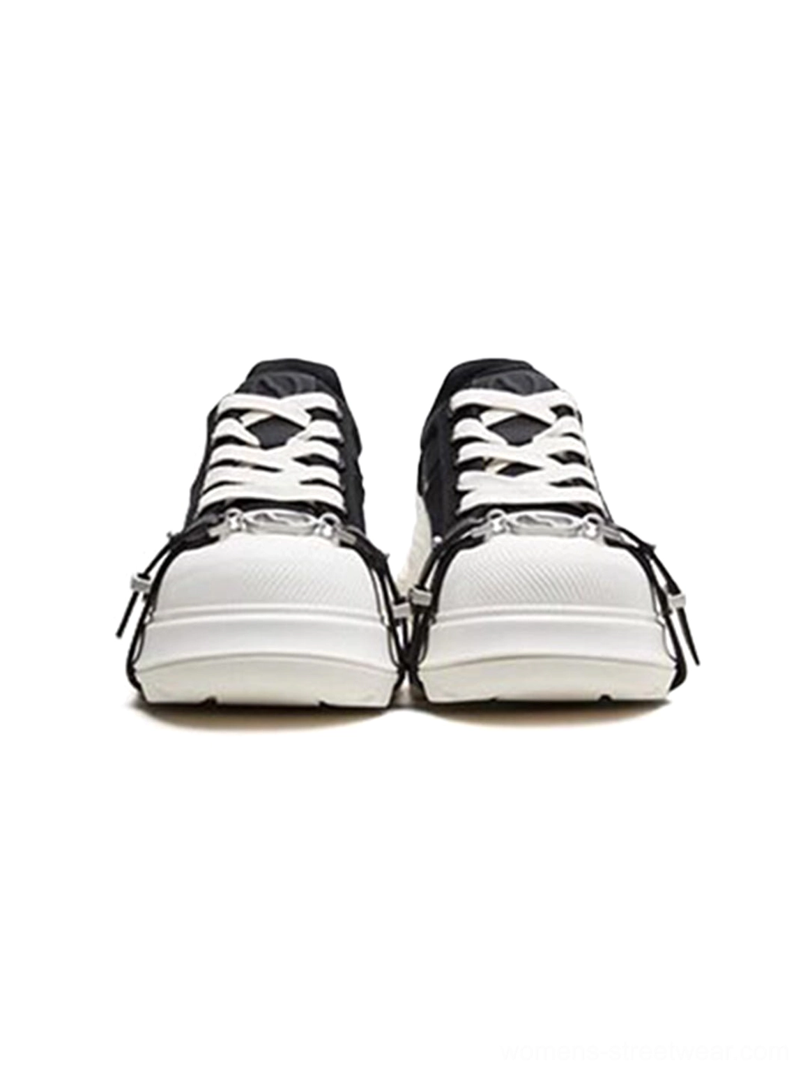 Close-up front view of black buckle platform canvas sneakers showing lace-up construction, silver toe buckles, contrast details, and thick outsole