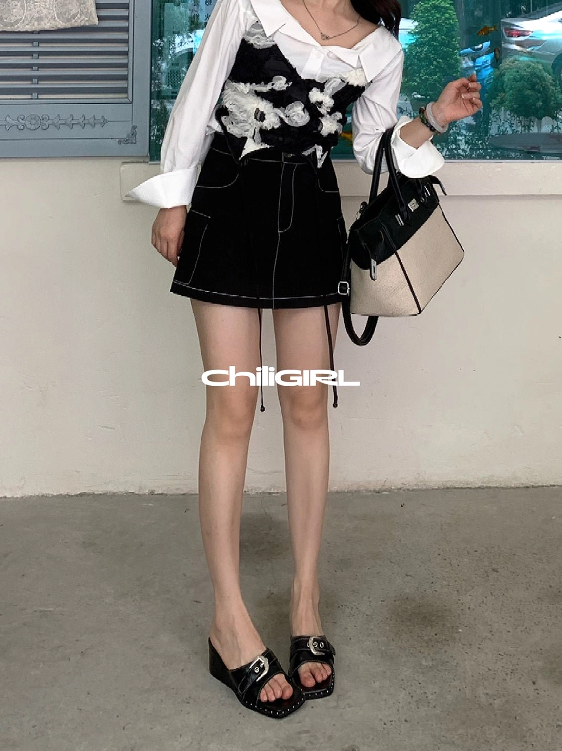 Black buckled square-toe sandals paired with a white blouse floral mini skirt and matching handbag