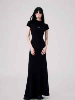 Black butterfly emblem fitted maxi dress shown from the front with mock neck short sleeves and a floor length fishtail hem