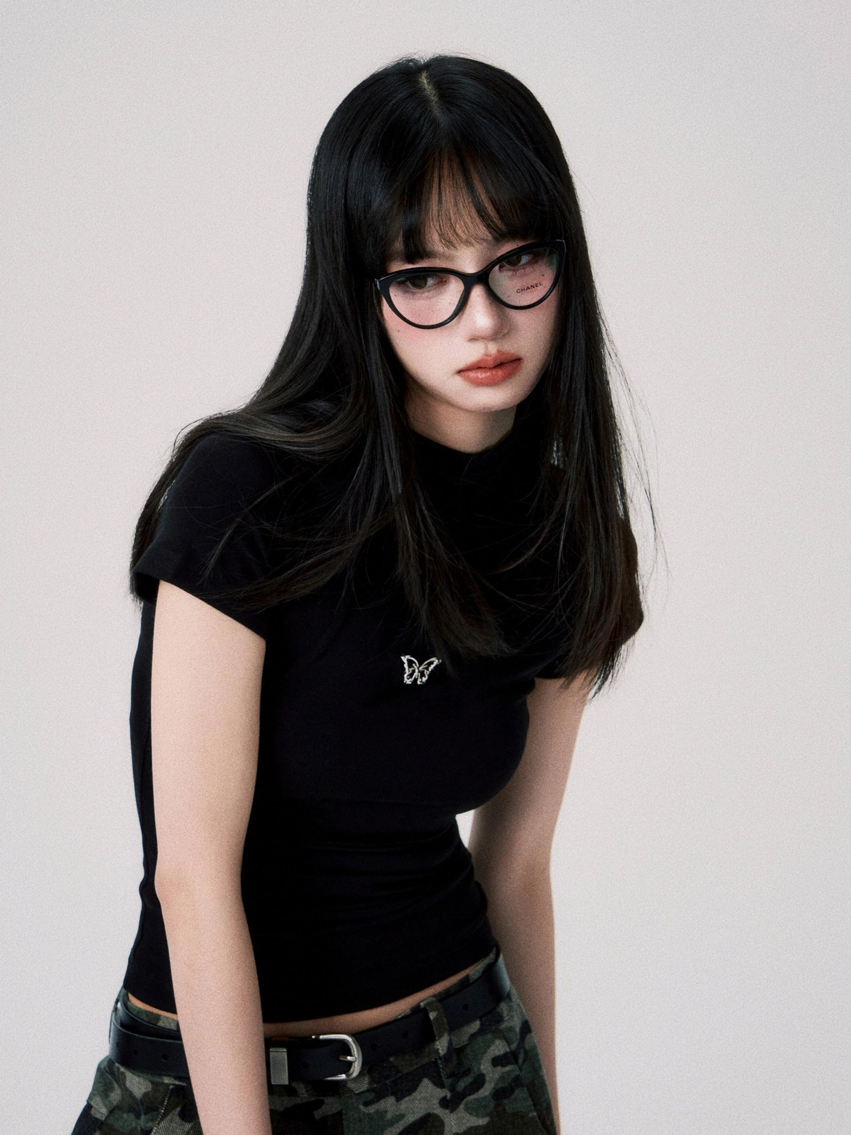 Black butterfly embroidered fitted crop tee with short sleeves styled with camouflage cargo pants