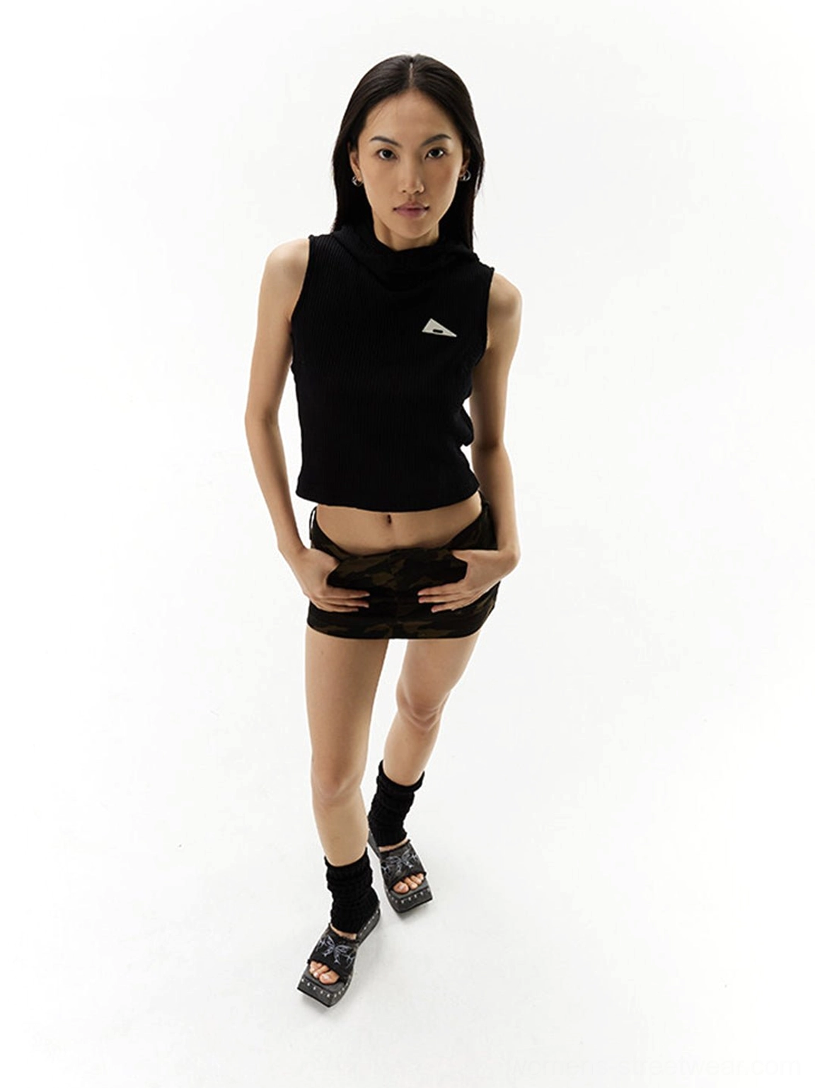 Black butterfly embroidered studded platform mules worn with camo mini skirt and black crop top