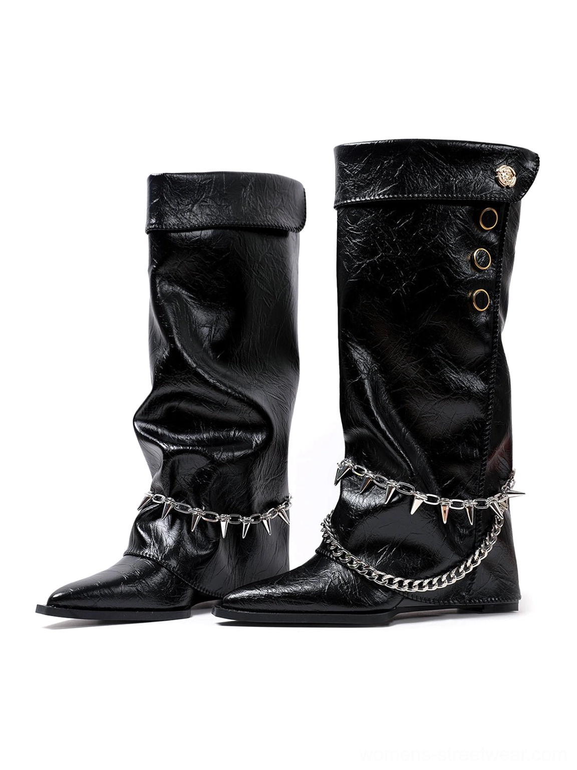 Side view of black chain-trim riding boots showing layered metal spike chains, fold-over shaft collars, button accents, and pointed toes