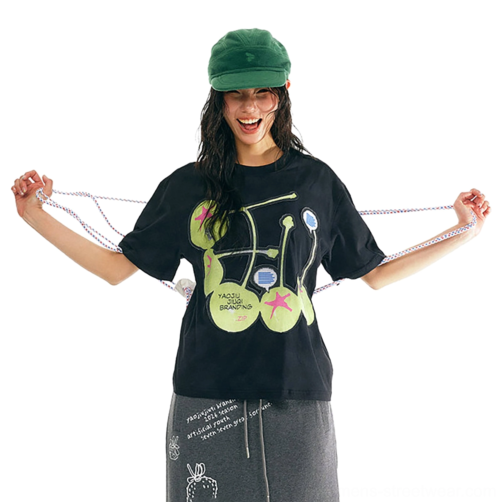 Black relaxed fit cherry graphic cotton t-shirt three-quarter front view showing lime green fruit print and short sleeves