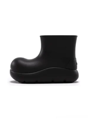 Black chunky ankle rain boot in matte black shown from the left front side with a rounded toe and thick platform tread sole