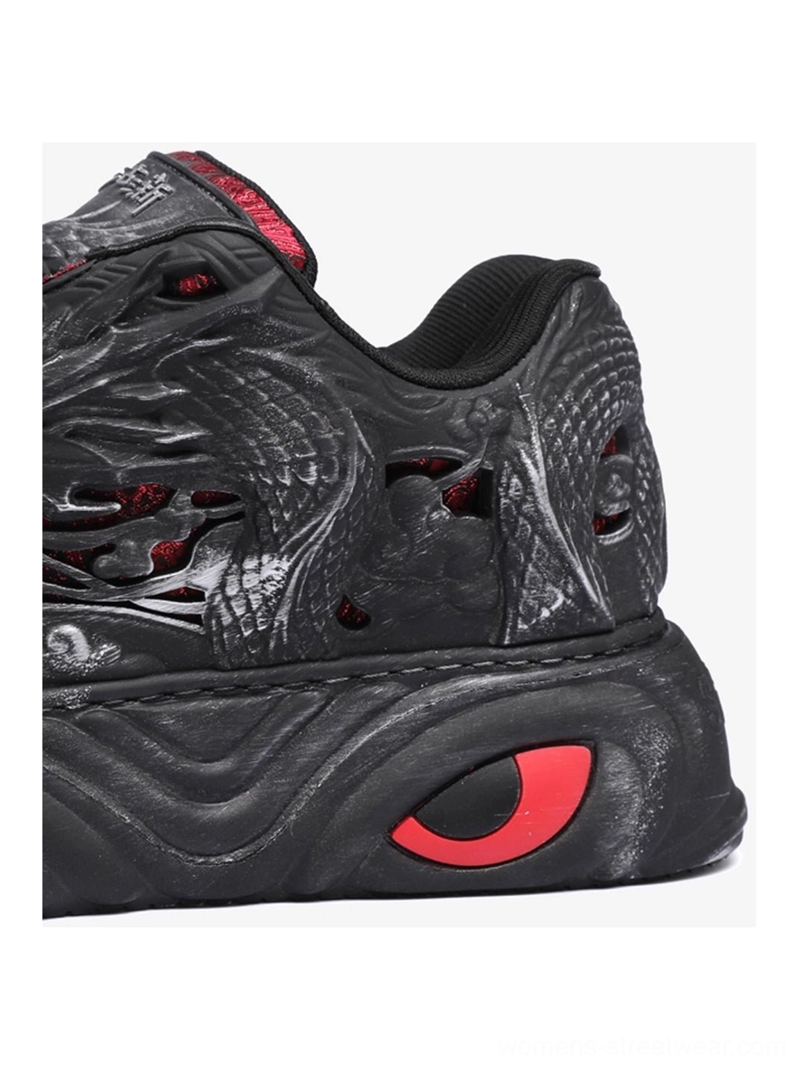 Black chunky dragon sneakers with raised relief artwork, layered technical panels, bold platform soles, and red detailing for urban streetwear