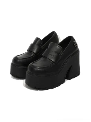 Pair of black chunky platform loafers with deep lug tread sole rounded toe and metal hardware shown from a top three quarter view