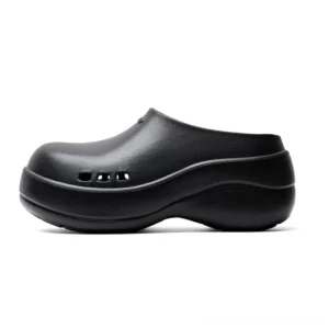 Black chunky platform clogs with rounded closed toe, three front ventilation holes, matte sculpted upper, and wavy anti-slip sole for Korean streetwear outfits