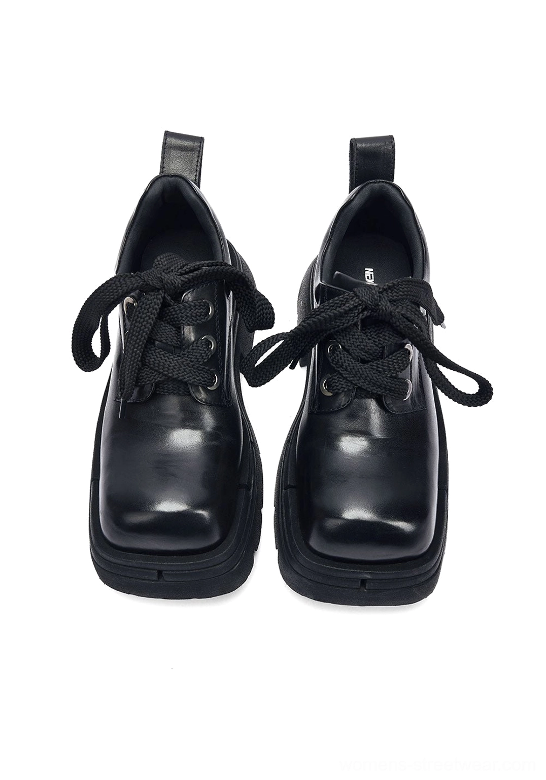 Front view of black chunky platform derby shoes with classic derby lacing, structured toe box, and ultra-thick layered platform sole