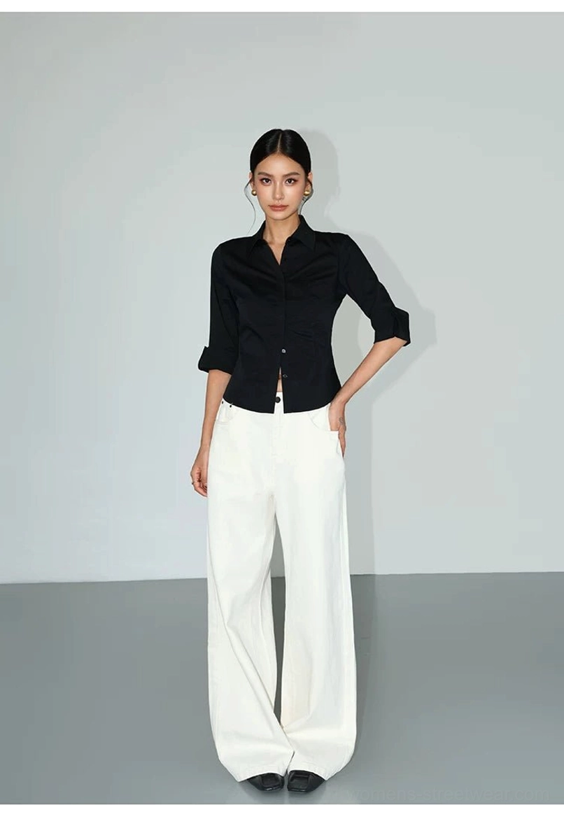 Black contour curve tailored button-up shirt with rolled cuffs paired with white wide-leg pants