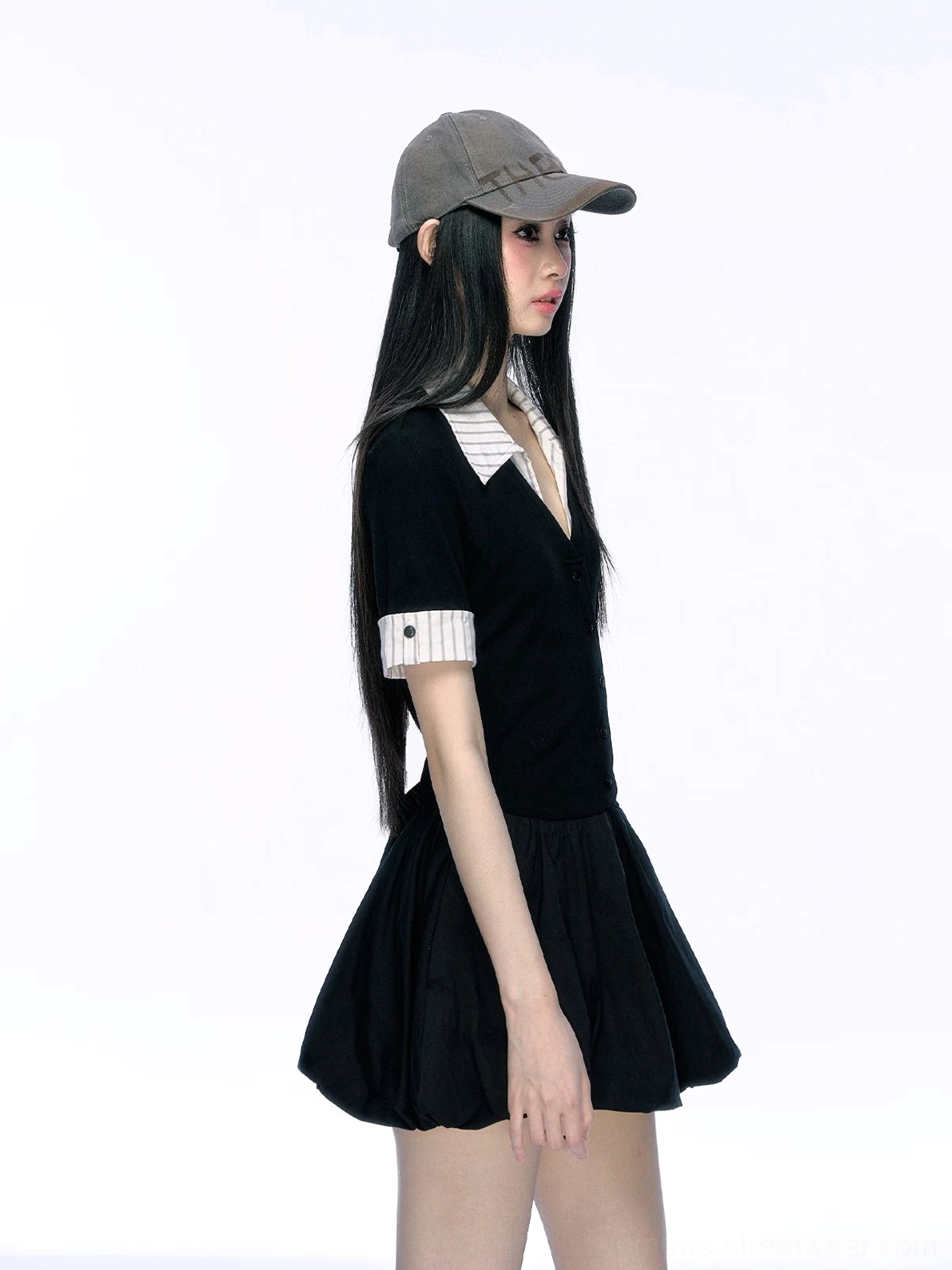 Side profile detail of black contrast collar mini dress showing striped sleeve cuff button detail and bubble hem silhouette