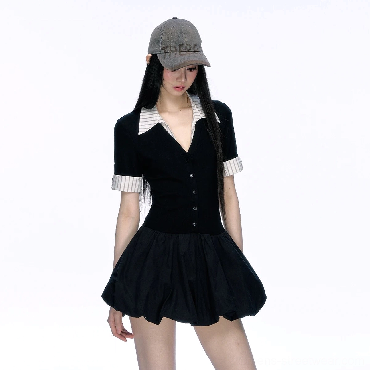 Low-angle front view of black contrast collar bubble hem preppy streetwear mini dress with fitted bodice and striped cuffs
