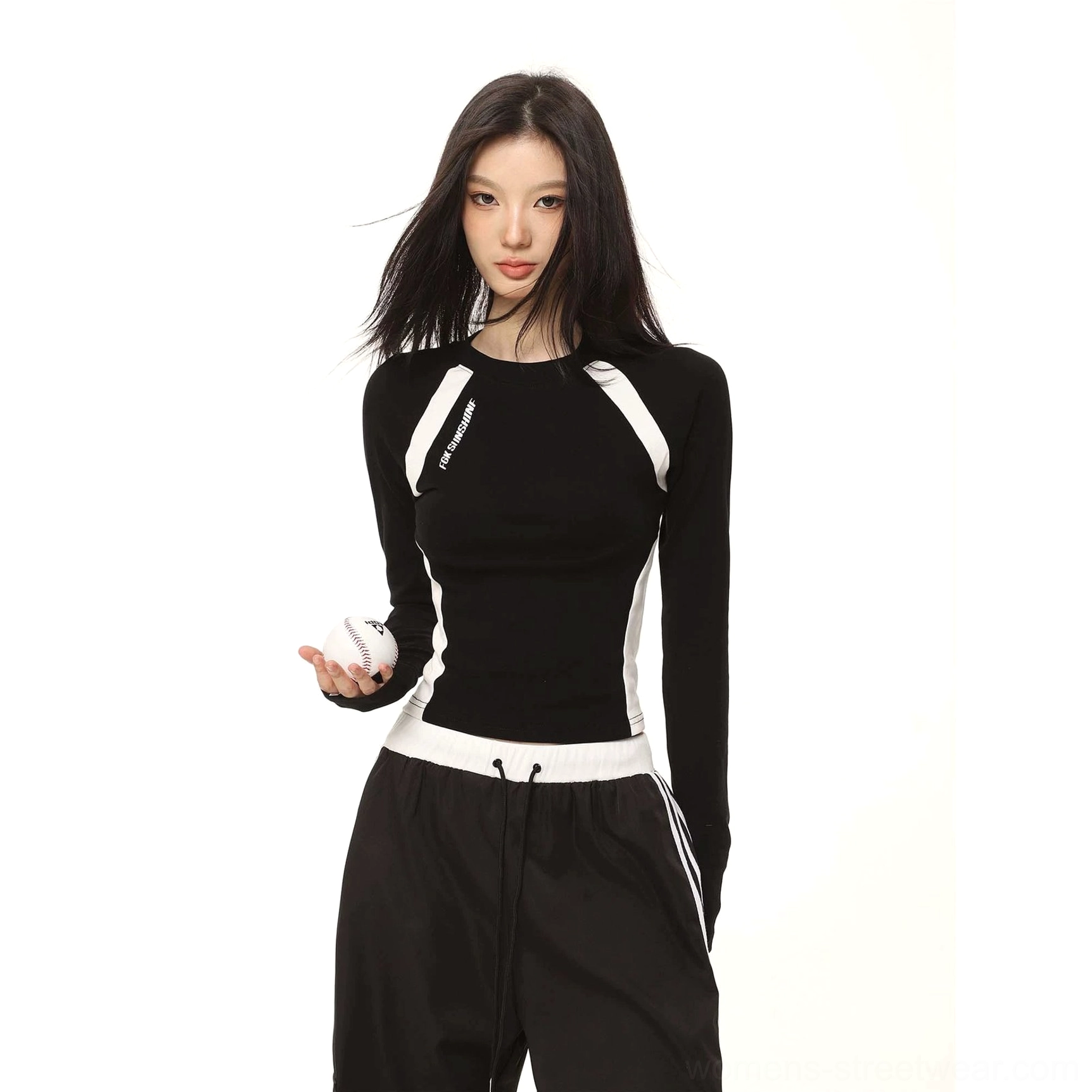 Black contrast color cropped long sleeve top close-up with white shoulder and waist panels and side letter print detail