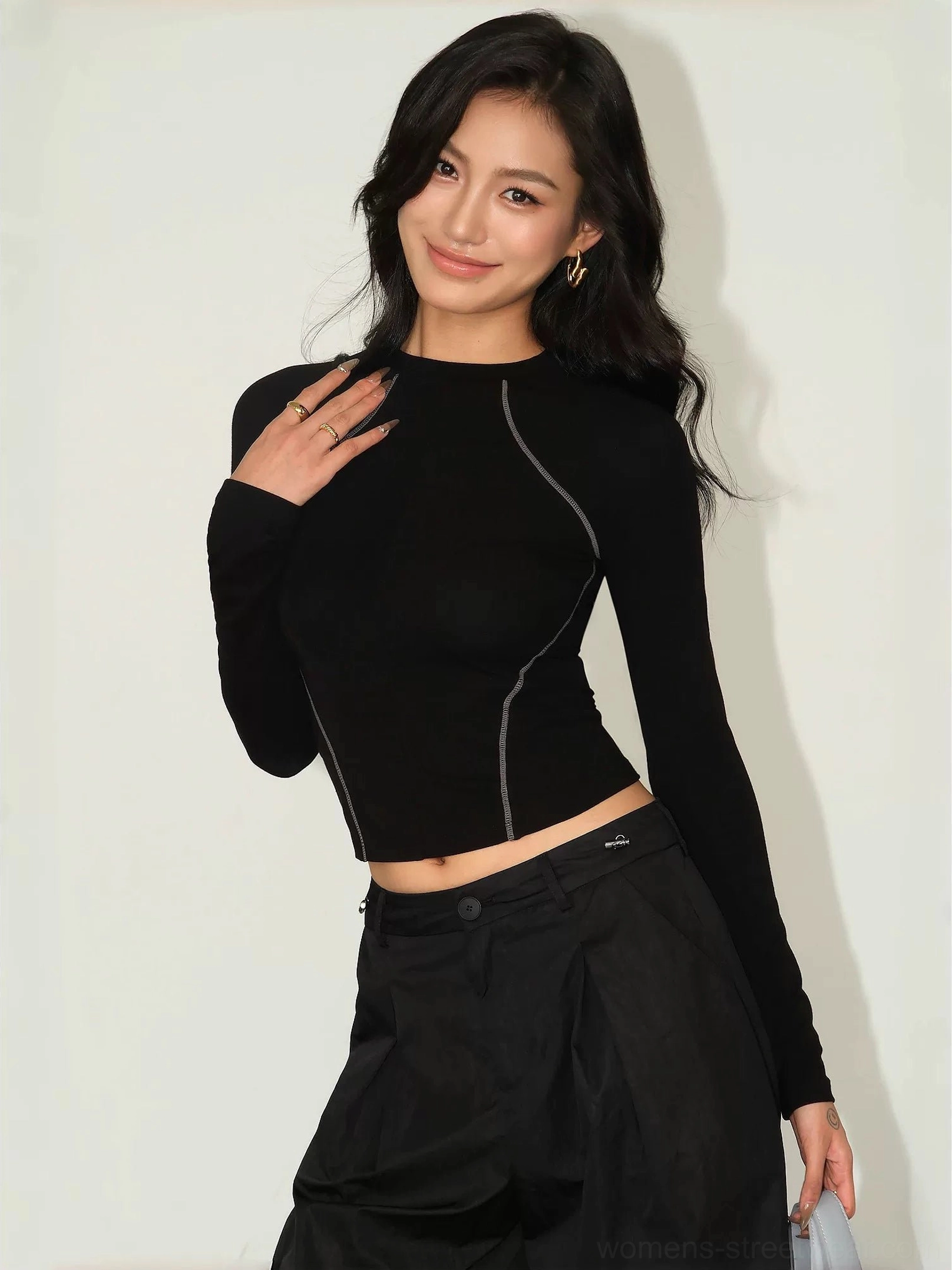 Black contrast stitch tee exposed waist crop with delicate earrings black cargo skirt minimalist design detail