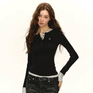 Black contrast trim Henley slim long sleeve streetwear top worn by model in minimalist studio