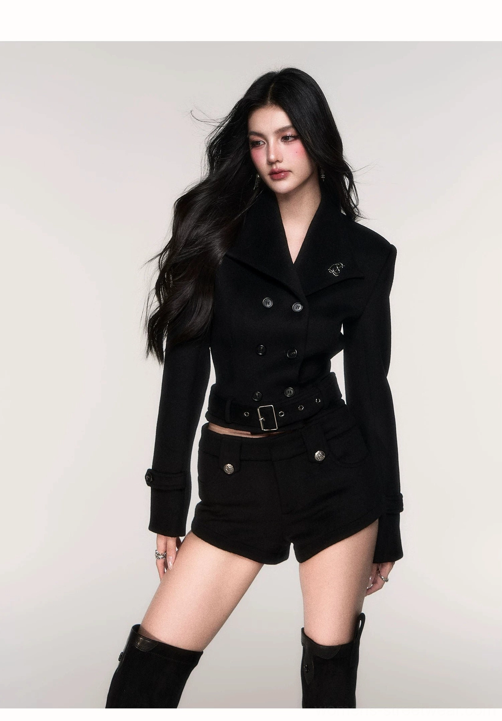Black cropped belted peacoat streetwear outfit with high waisted shorts and over the knee boots