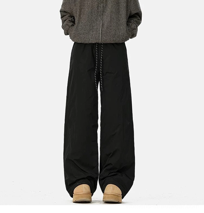Black convertible fleece-lined wide-leg streetwear pants styled with a gray fleece jacket and platform snow boots