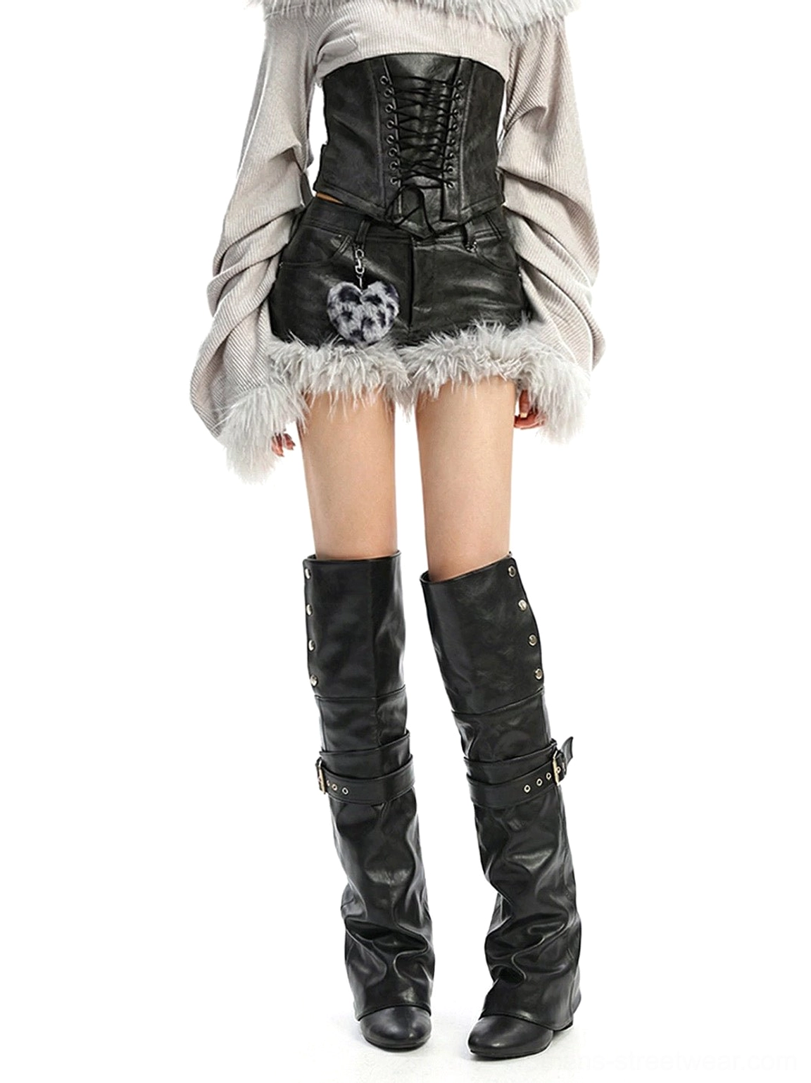 Low angle front view of model wearing black thigh-high slouch riding boots with a convertible foldover shaft
