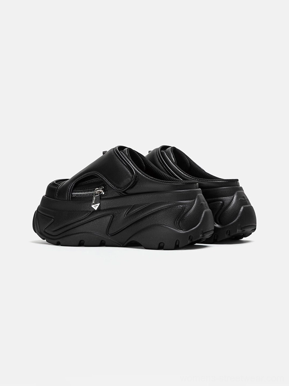 Black covered-toe platform slide sandal in low side profile with matte upper, front silver zipper detail, thick sporty outsole, and urban streetwear styling
