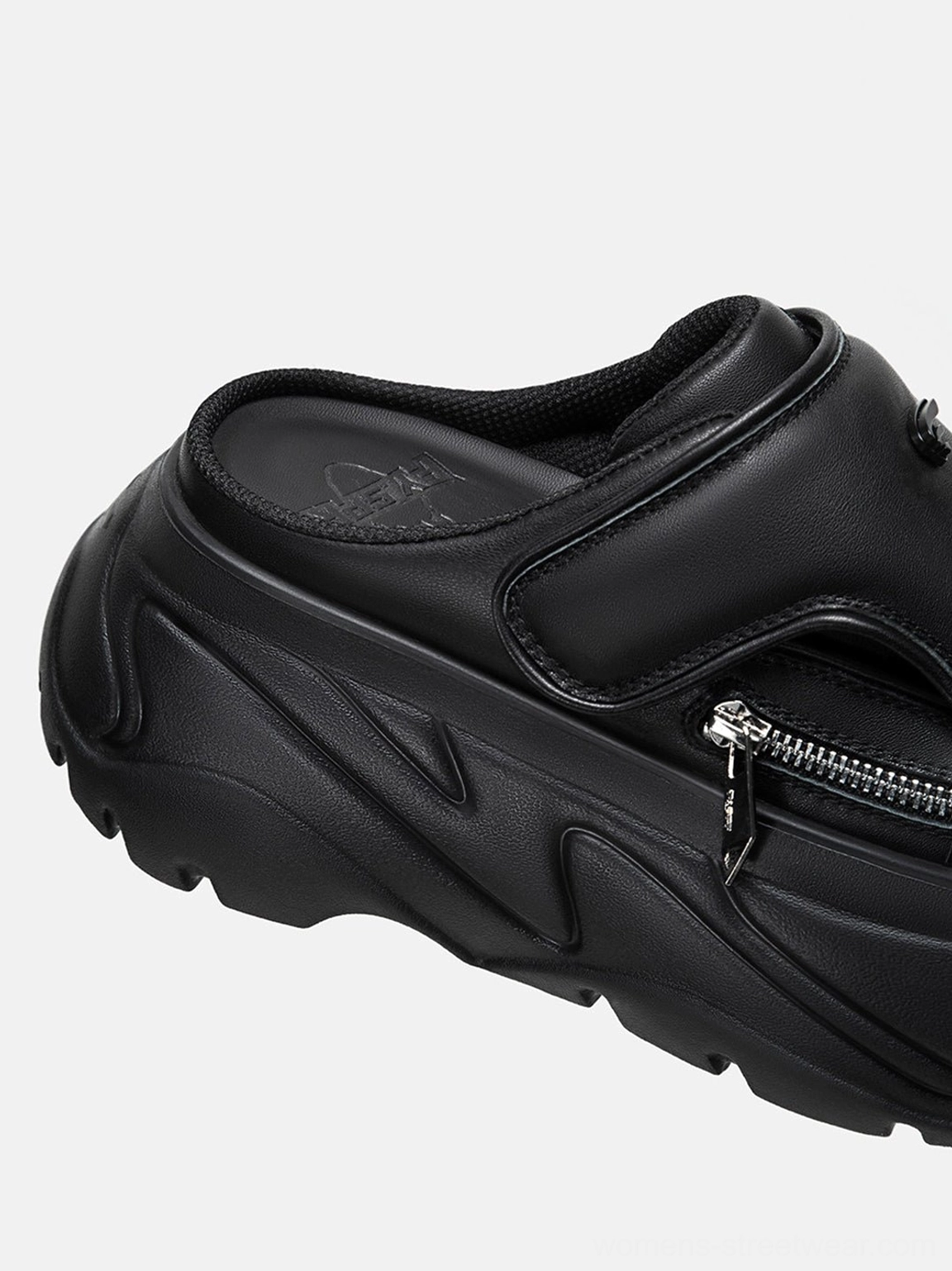 Black covered-toe platform slide sandals with chunky techwear sole, square toe, textured upper, silver zipper accents, and modern Korean streetwear style