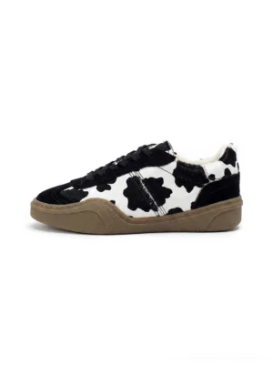 Black cow print leather low-top streetwear sneakers in left side profile with black suede overlays and brown gum rubber sole