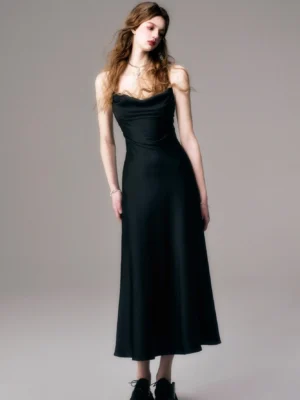 Black cowl neck satin slip maxi dress with spaghetti straps and flowing floor length skirt front three quarter view