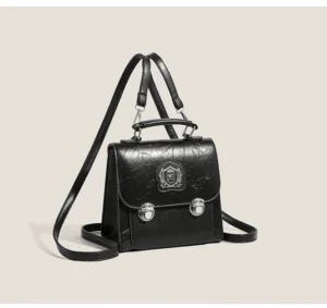 Black crested mini satchel bag in textured crinkle PU with silver hardware, front flap, top handle, and adjustable crossbody strap