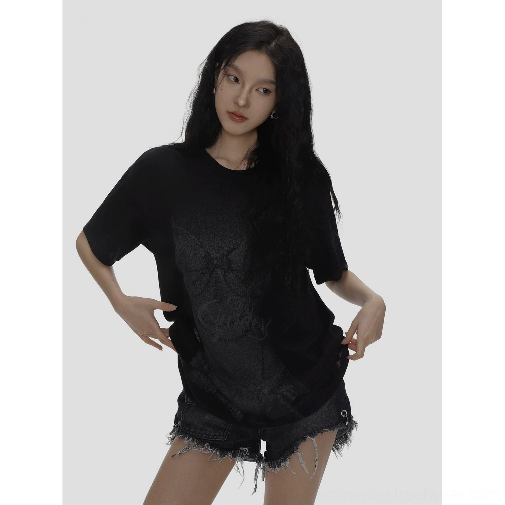 Black crew neck oversized T-shirt with bow and cursive graphic front print close-up