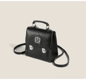 Black crinkle PU crested mini satchel crossbody bag with silver buckles, top handle, and detachable shoulder strap front view