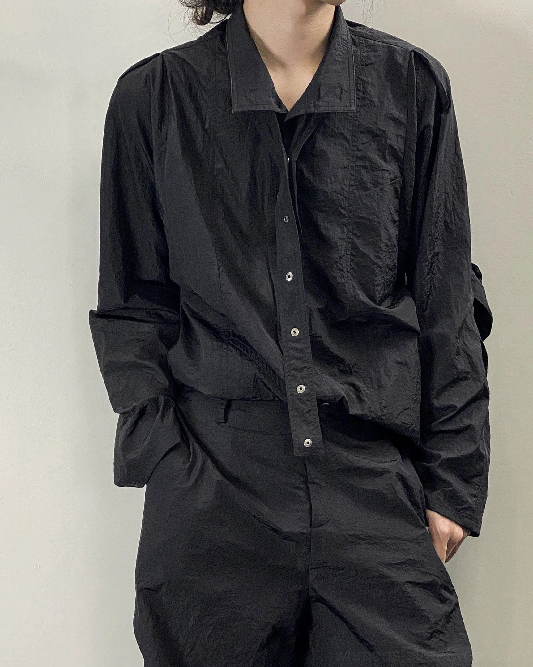 Black crinkled oversized long sleeve shirt with stand collar worn in a full front streetwear outfit