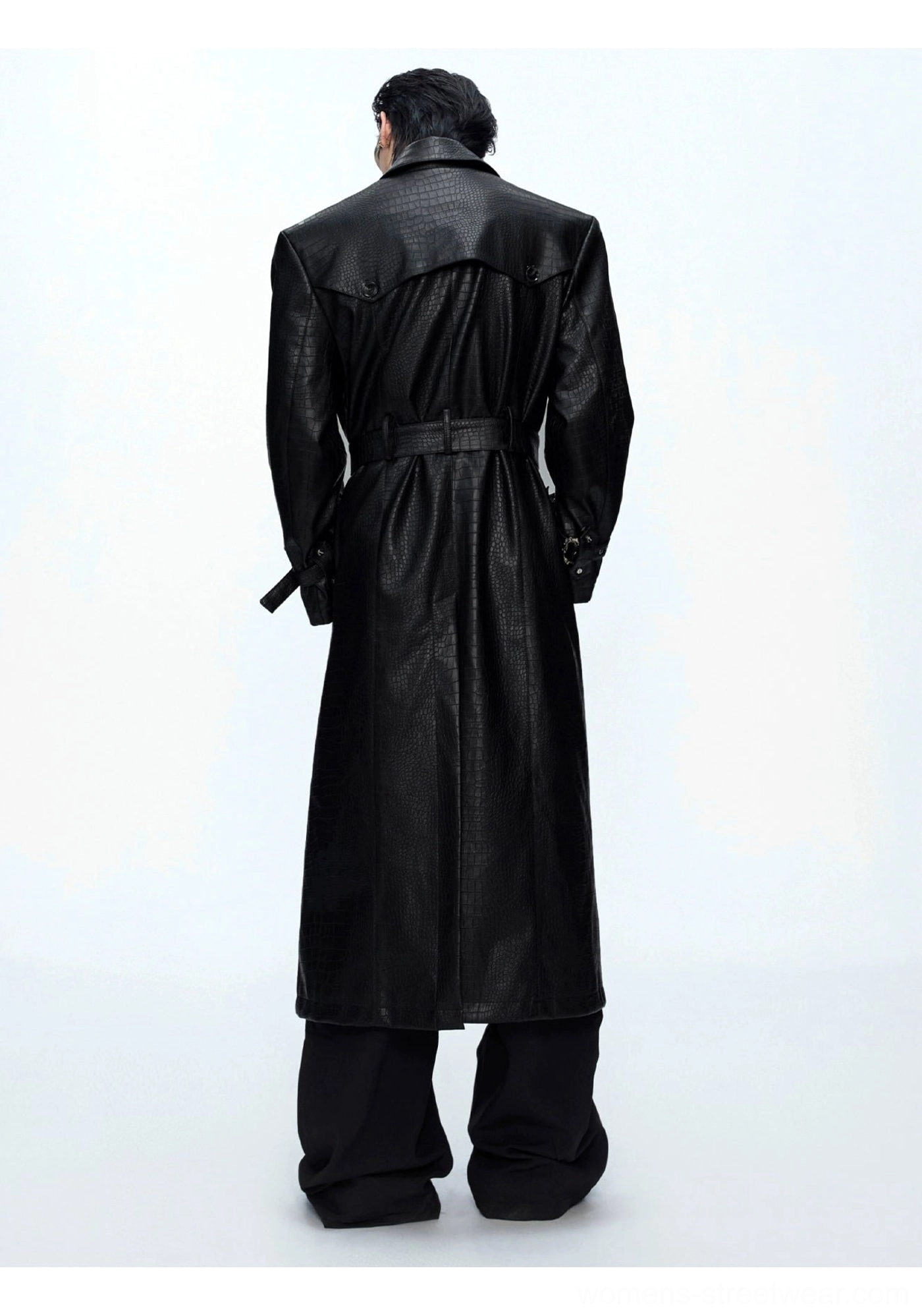Back full-body view of black glossy croc-embossed leather trench coat showing long tailored back panel and adjustable waist belt