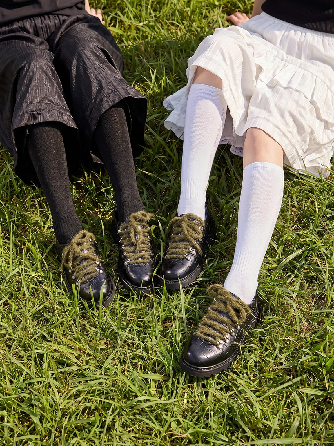 Pair of black crocodile-textured leather derby shoes with olive laces shown with varied socks and casual streetwear outfits