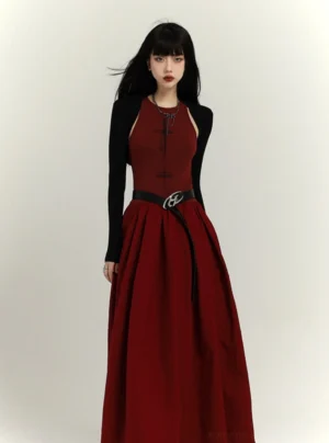 Full-body view of a black cropped cardigan bolero layered over a wine red pleated maxi dress in modern Y2K streetwear styling