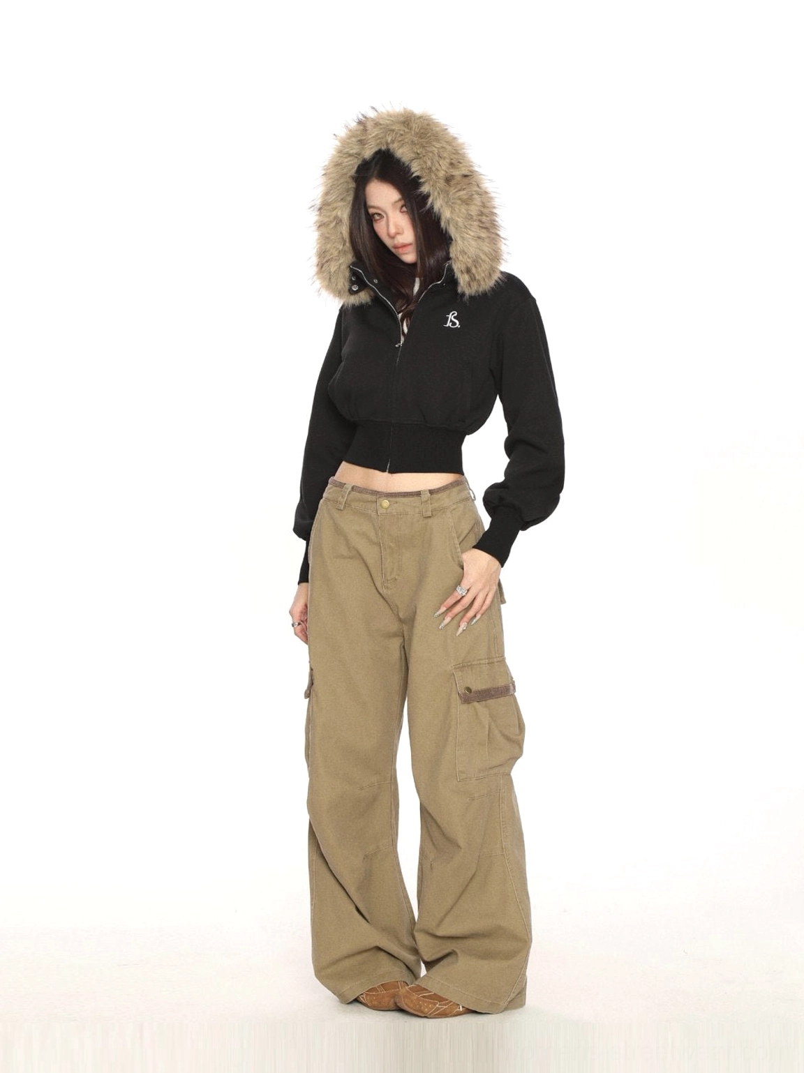 Full-body black cropped faux-fur hood zip-up sweatshirt styled with high-waisted wide-leg khaki cargo pants