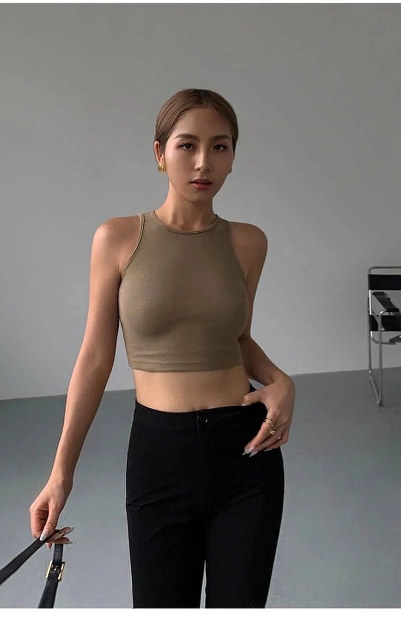Black cropped knitted tank top K-fashion inspired silhouette - sleeveless cropped length showing midriff following Korean street style and Seoul fashion district trends