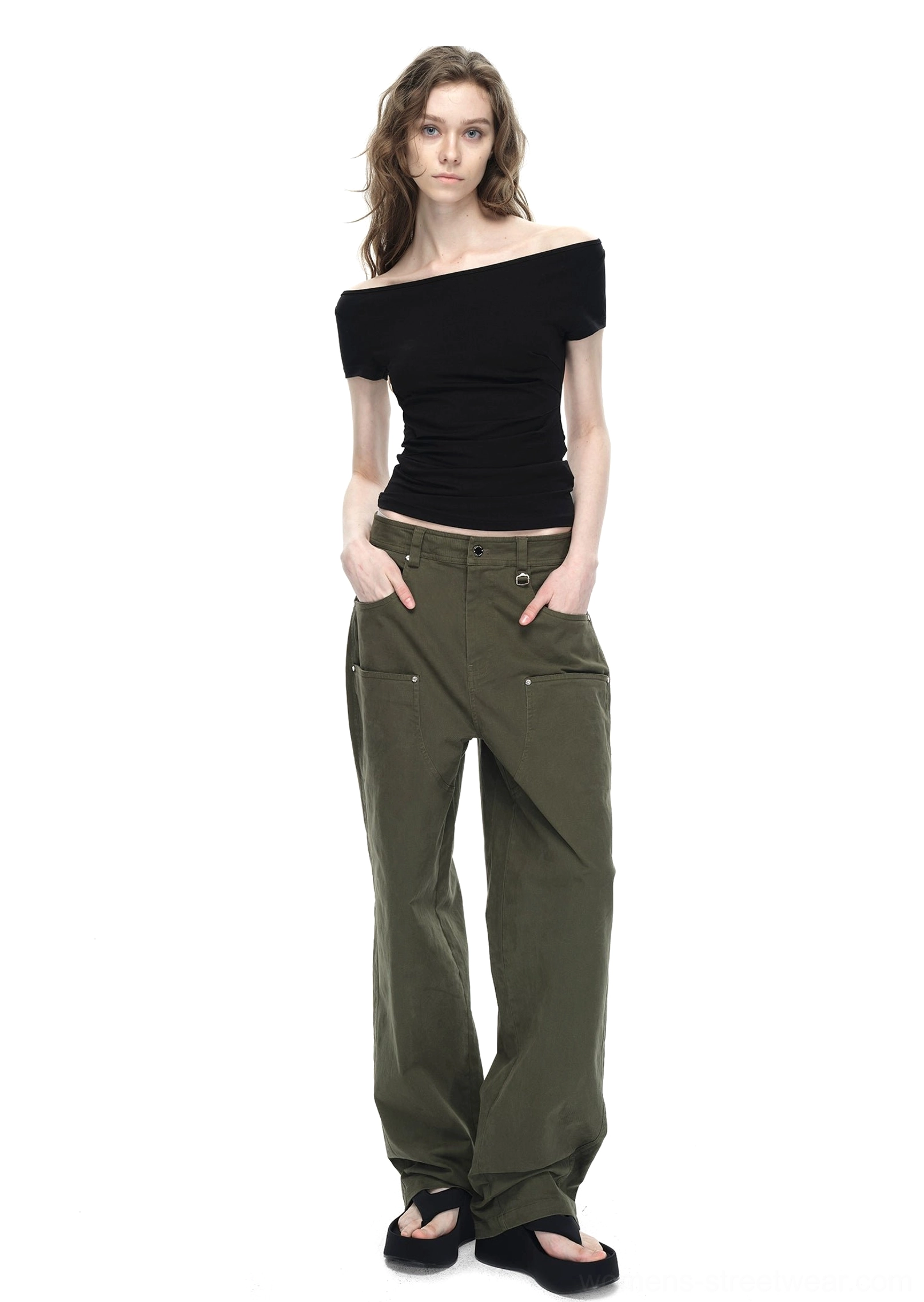Black cropped off-shoulder backless streetwear T-shirt styled with olive cargo pants and black slides