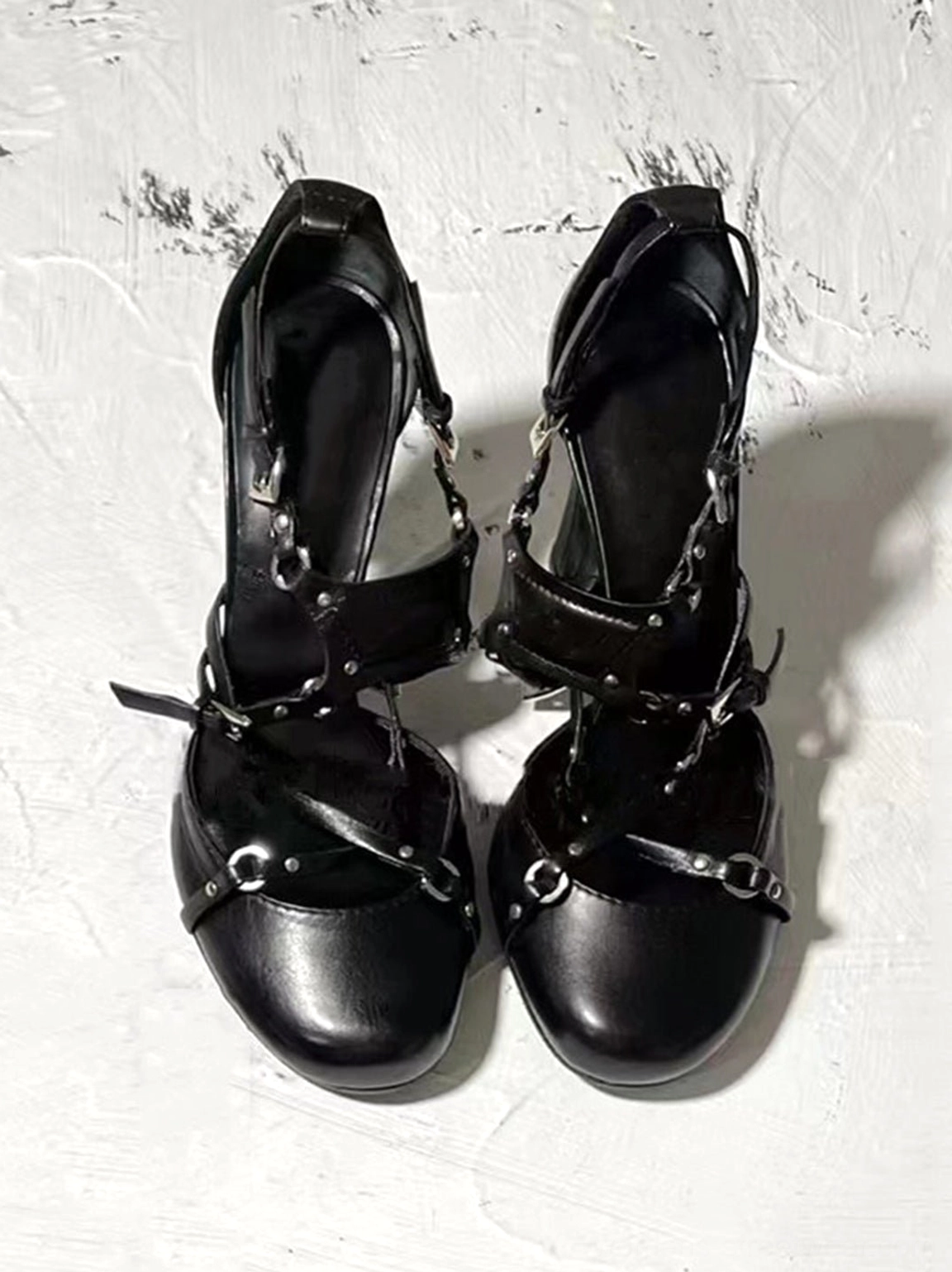 Black cross-strap round-toe high heel pumps with smooth matte synthetic upper, silver-tone hardware, and black inner lining