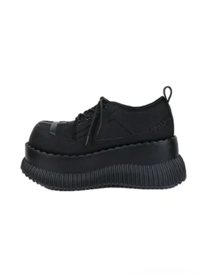 Black cross toe chunky platform lace-up shoes in a left front overhead product view showing the rounded toe, decorative stitching, and thick ridged sole