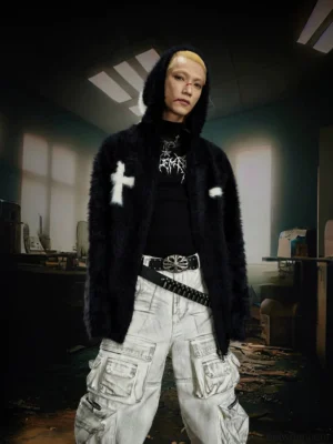Black faux fur hooded zip jacket with white cross embroidery styled with urban cargo pants