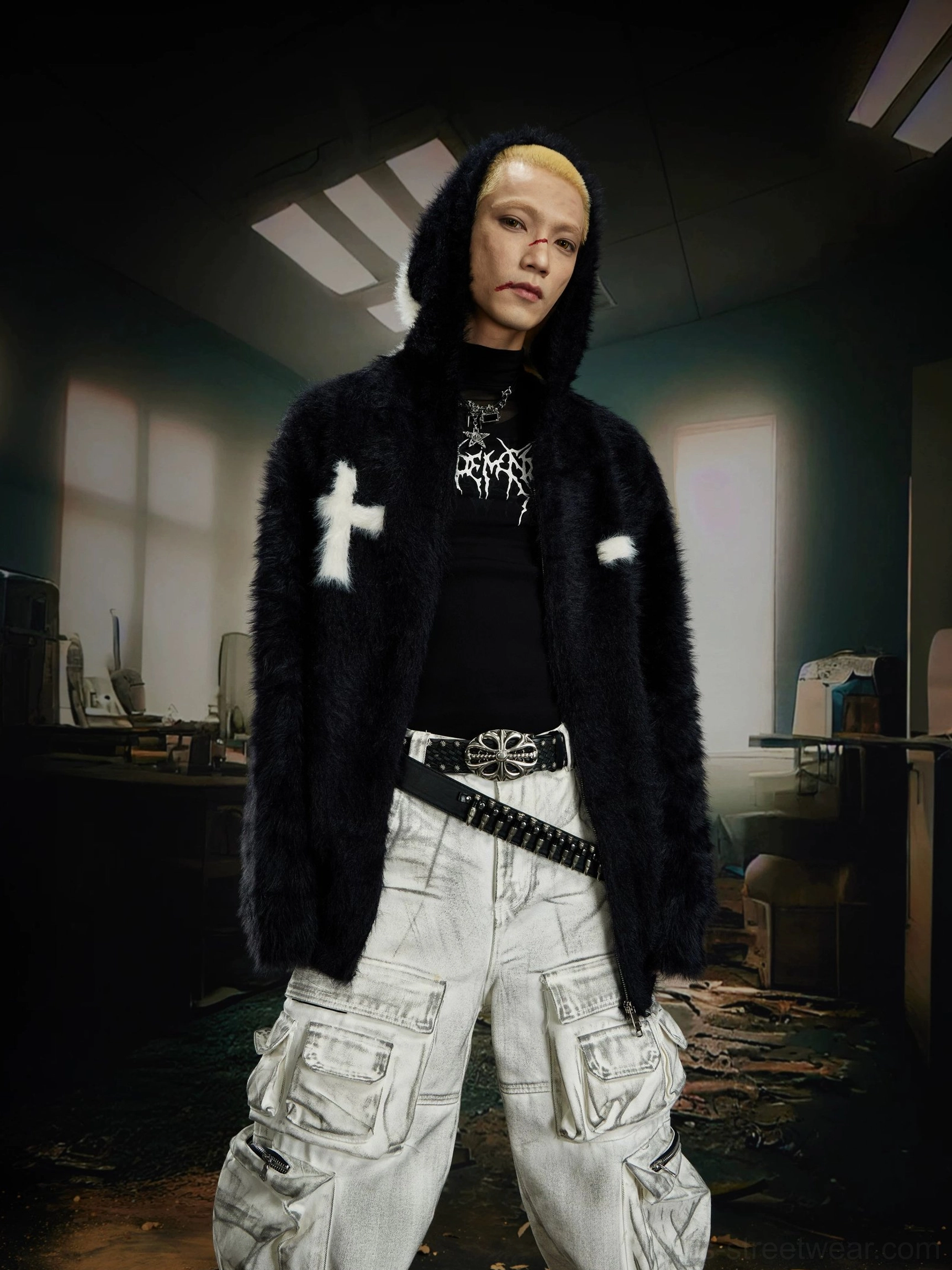 Black faux fur hooded zip jacket with white cross embroidery styled with urban cargo pants