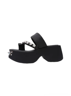 Black crystal-trimmed platform thong slides shown in a left side profile with chunky black sole, silver gemmed toe hardware, and sparkling streetwear sandal details