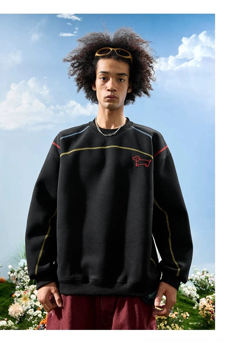Black dachshund embroidered oversized crewneck sweatshirt with red chest motif and relaxed streetwear fit worn by a male model