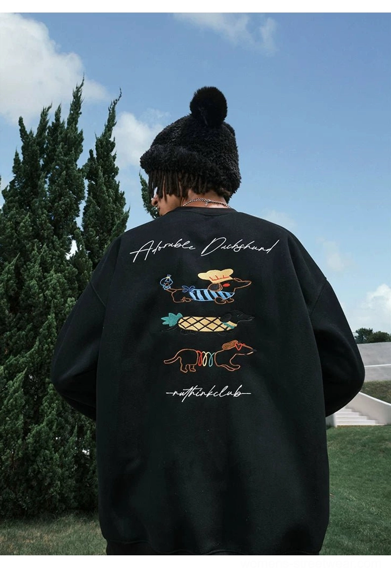 Black oversized dachshund sweatshirt featuring three neat colorful dog patterns and handwritten graphic details across the back