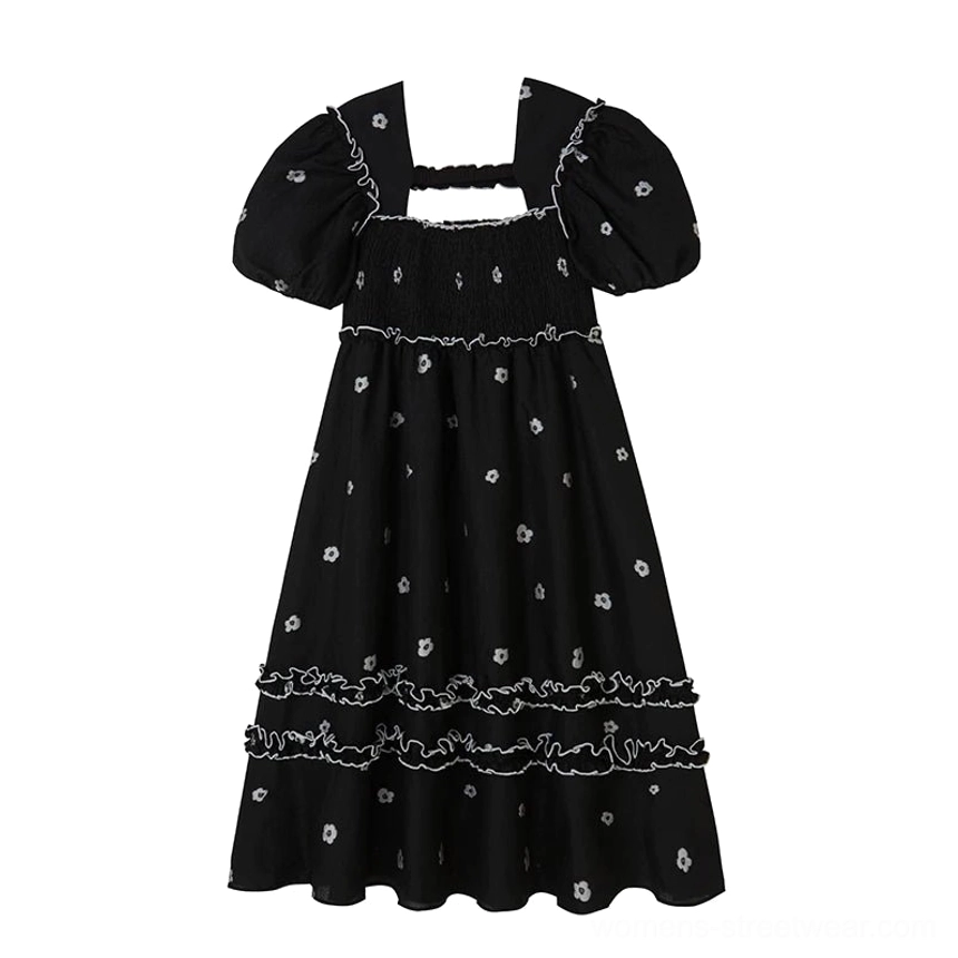 Flat lay view of a black daisy detail square-neck midi dress with puff sleeves, shirred bust, A-line skirt, and ruffled layers