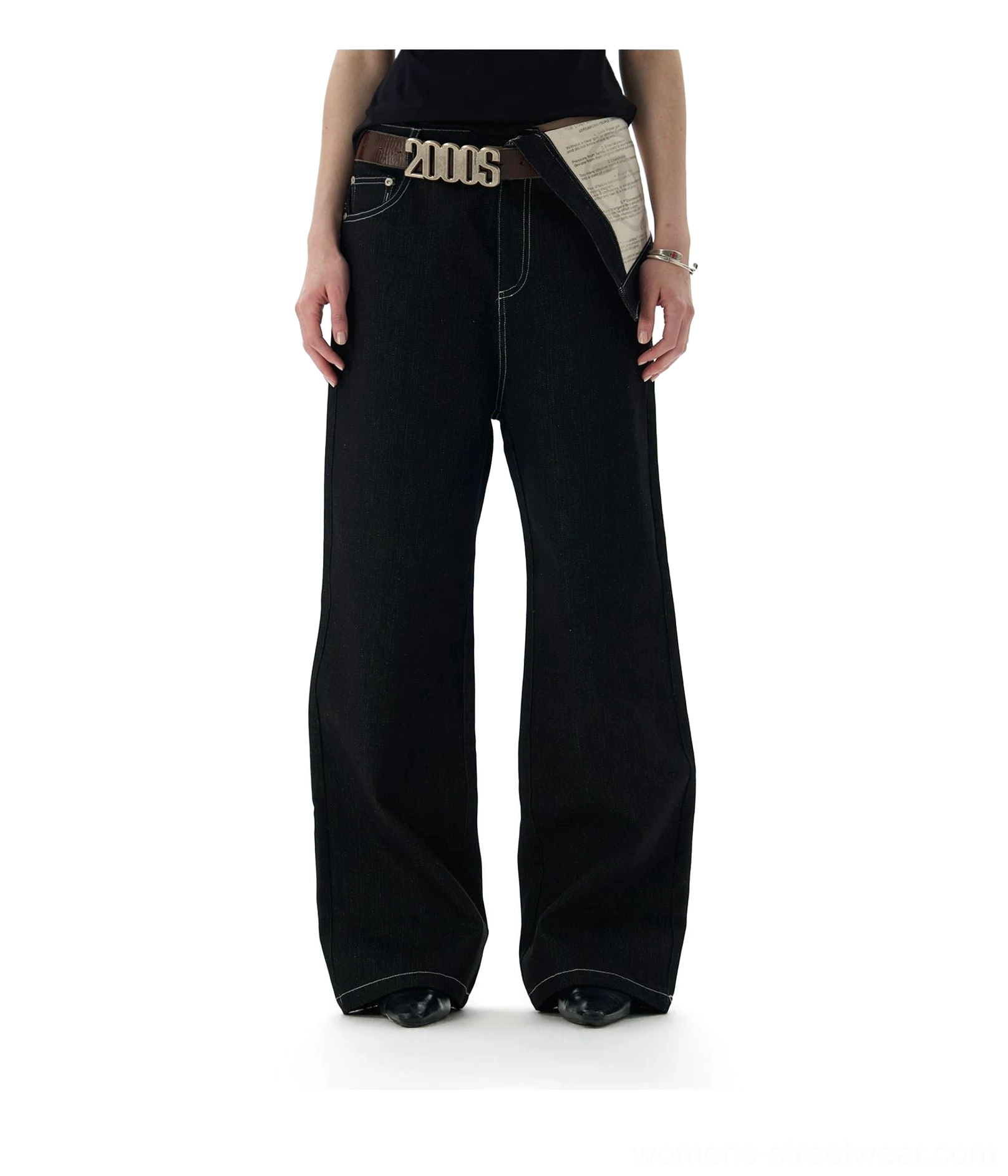 Flat lay of black deconstructed contrast waist jeans with white topstitching and full-length straight-leg design