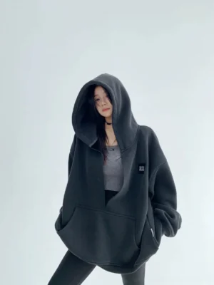 Black deep cocoon oversized fleece hoodie front three-quarter view with extra-large hood and kangaroo pocket