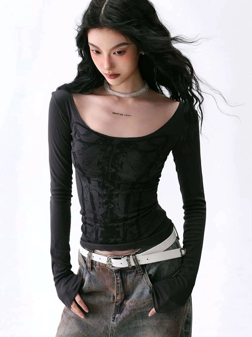 Close-up view of black slim-fit deep U-neck long sleeve top with tonal corset print and layered necklaces